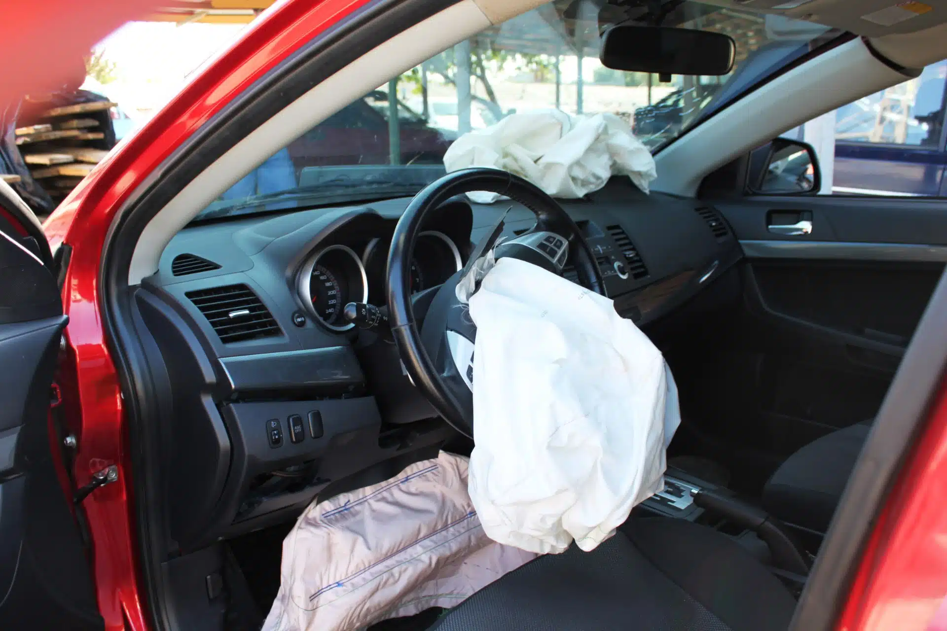 Deflated airbags are shown inside a red vehicle - Honda vehicles