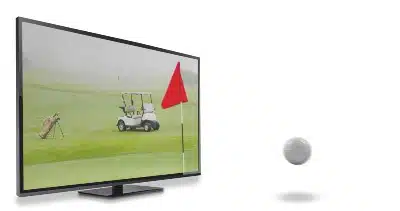 A TV shows a golf cart, flag and clubs on a course as the ball bounces out of the TV - NBCUniversal