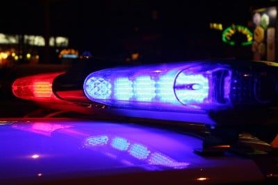 Police lights on top of car at night - LAPD officers