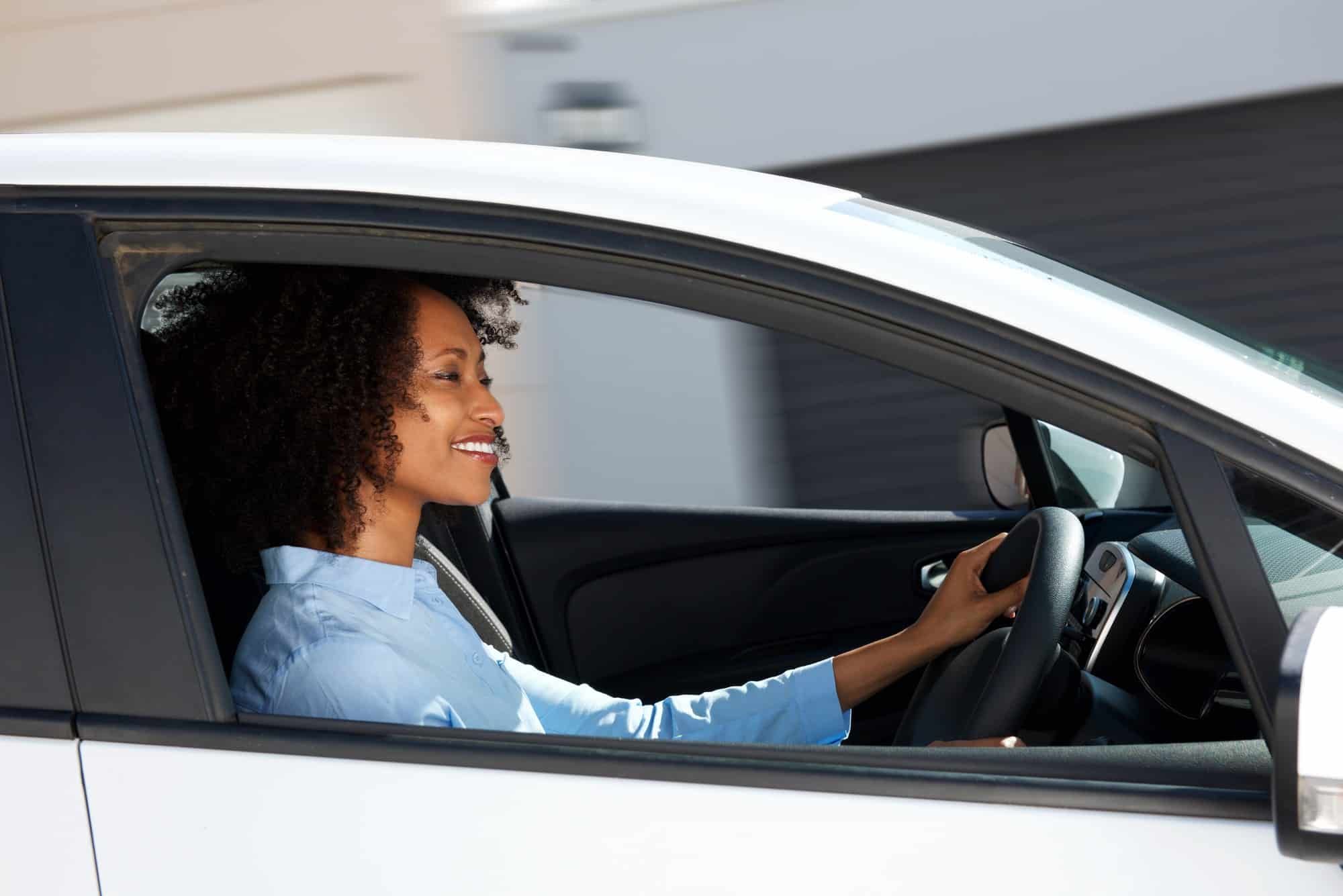 Side portrait woman drives car