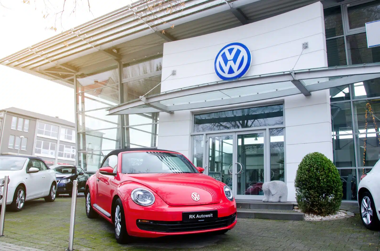 Cars surrounding entrance to Volkswagen dealership - volkswagen automatic braking system