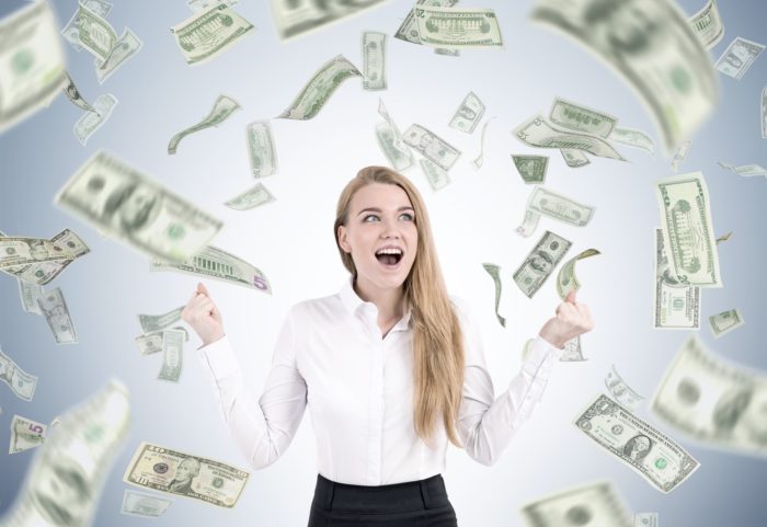woman surrounded by class action rebates money