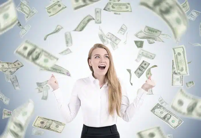 woman surrounded by class action rebates money