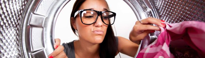woman doing laundry with Tide PurClean laundry detergent