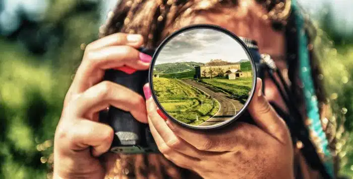 woman using a camera she rented on LensToGo website