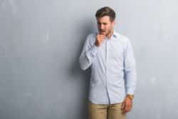 Man coughing into his closed fist