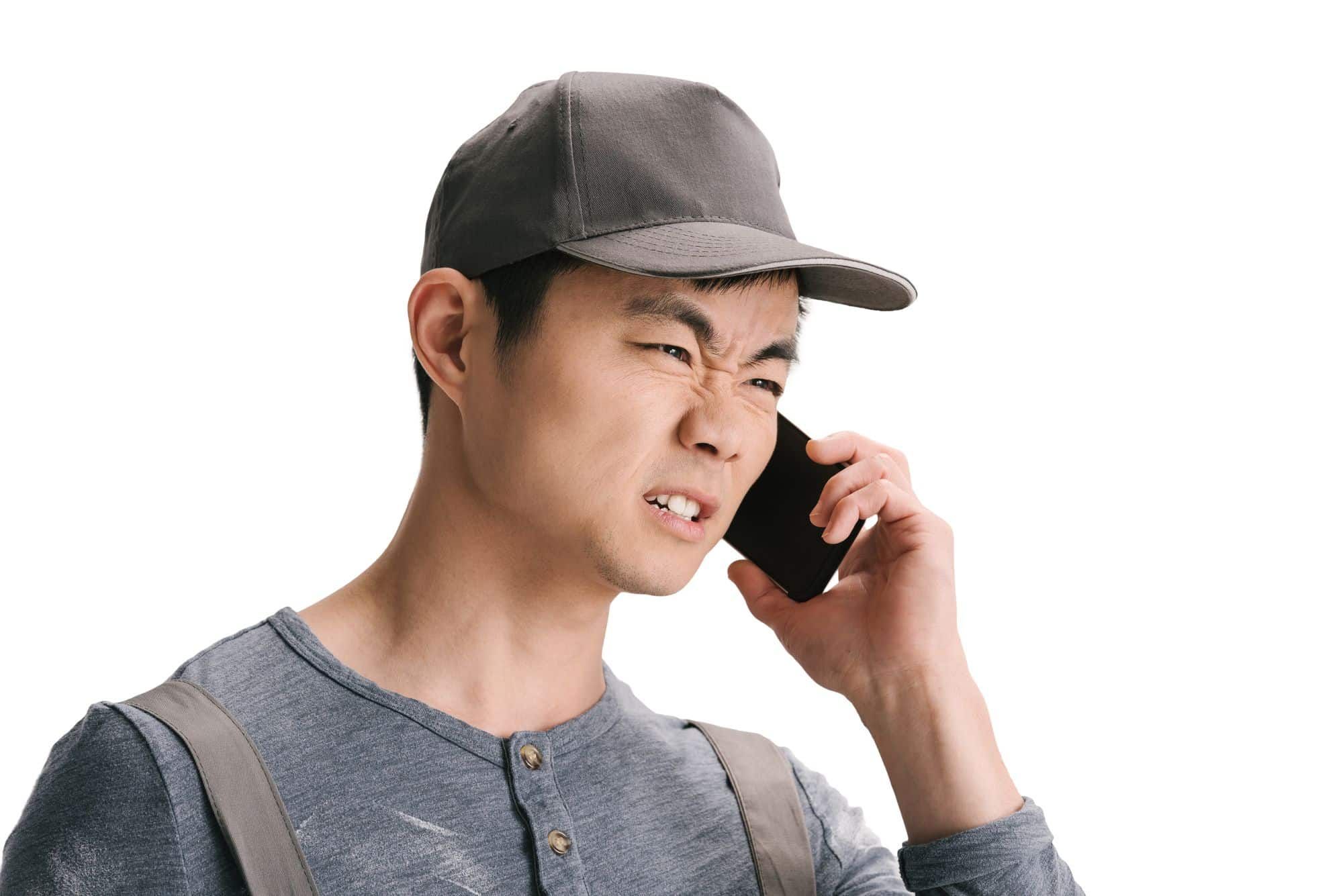 angry asian man dealing with robocall