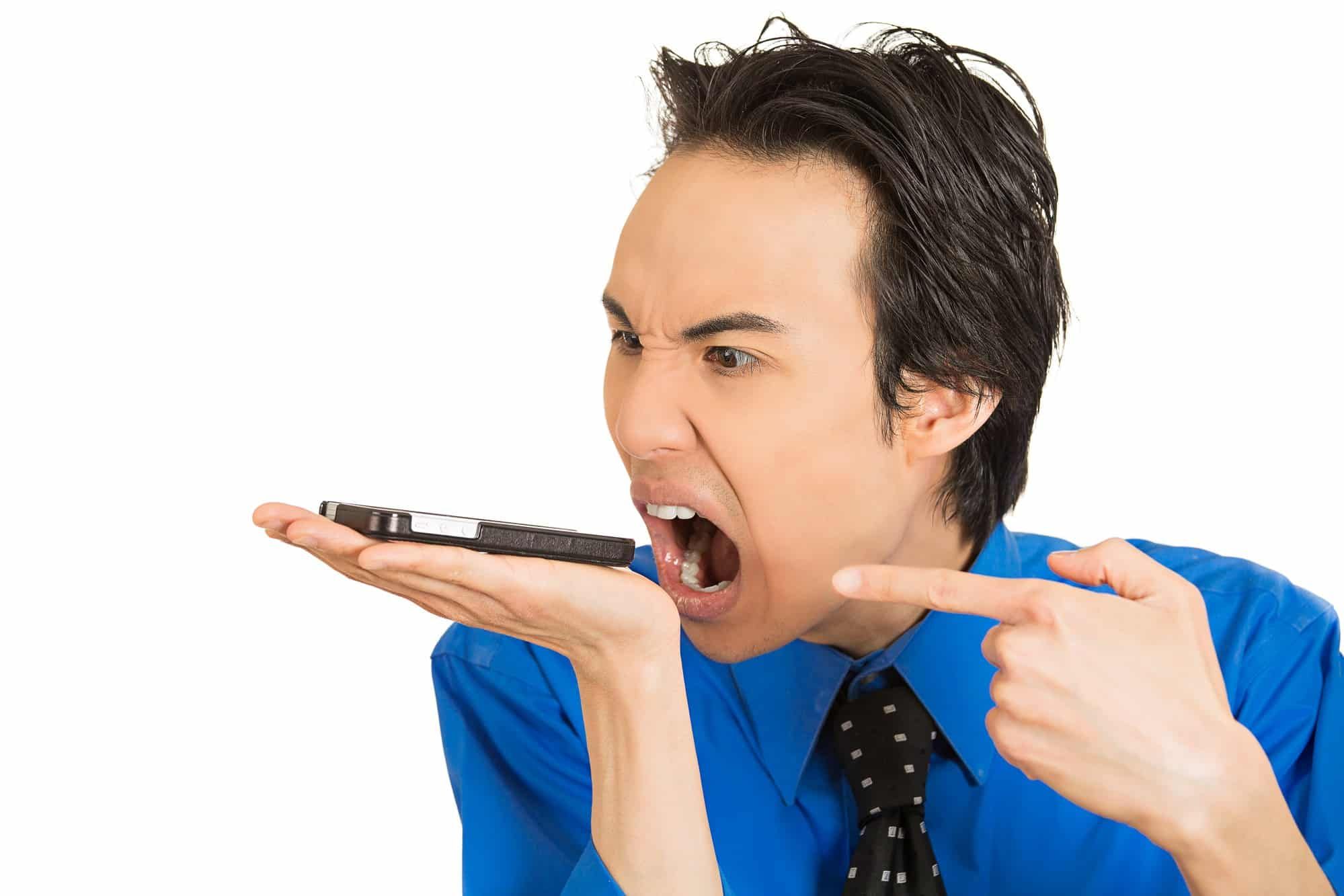 angry young man yelling at phone