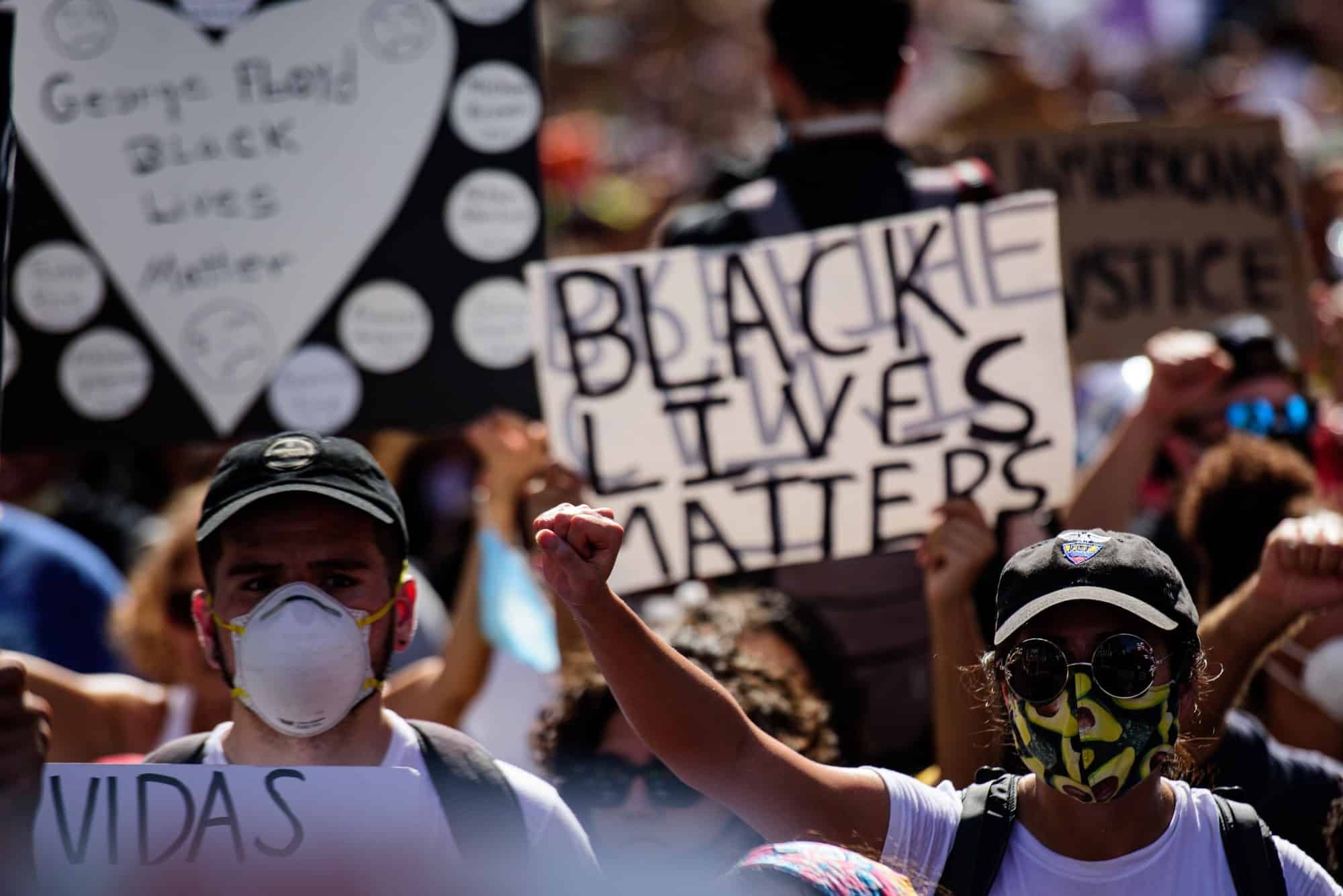 Crowds protest police brutality.
