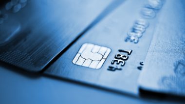 Closeup of three credit cards fanned out on table - capital one credit card