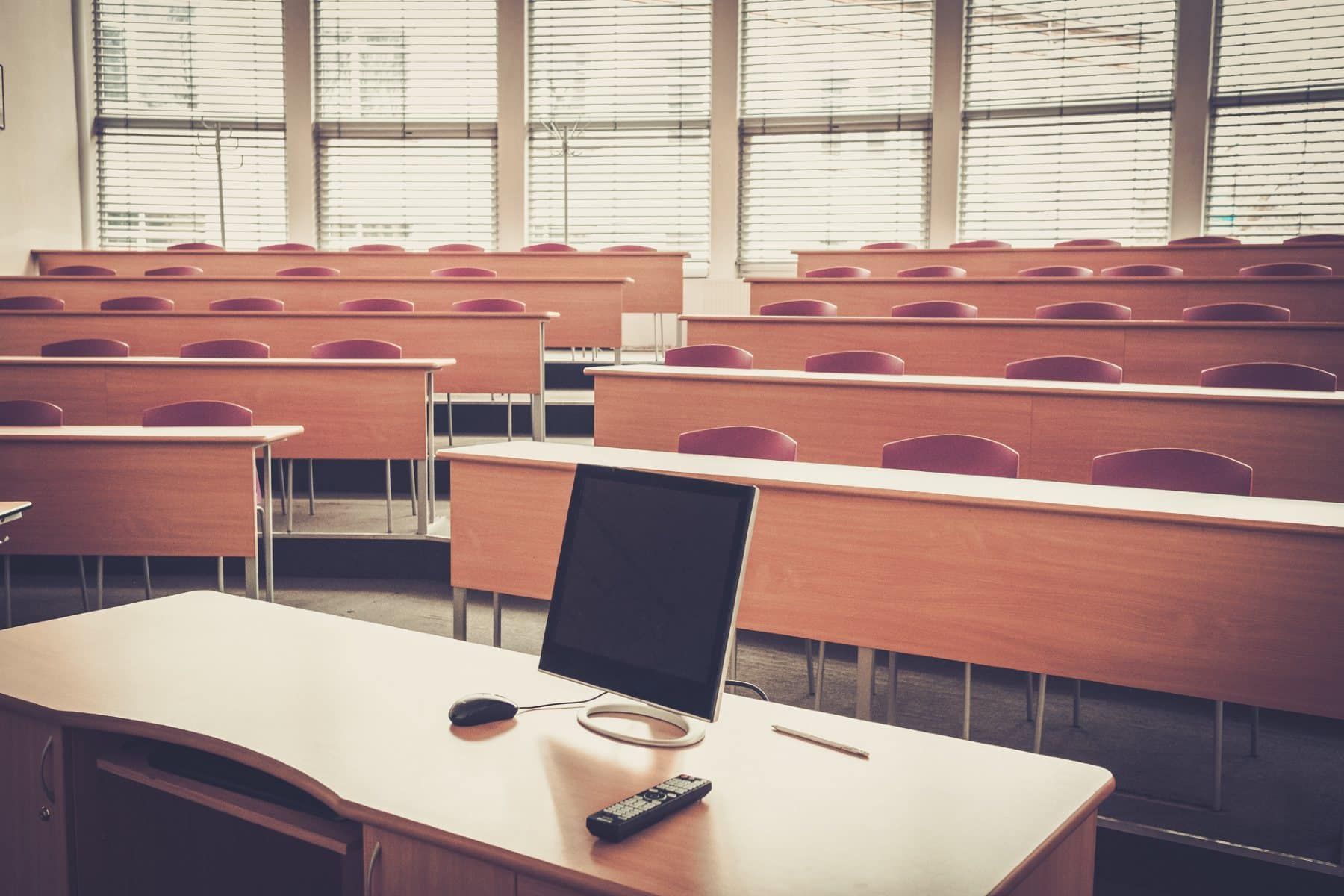 A university lecture hall sits empty - college tuition