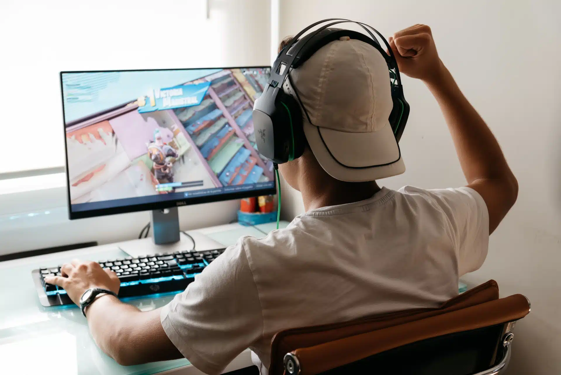 Teen boy plays Fortnite on PC - Fortnite game app