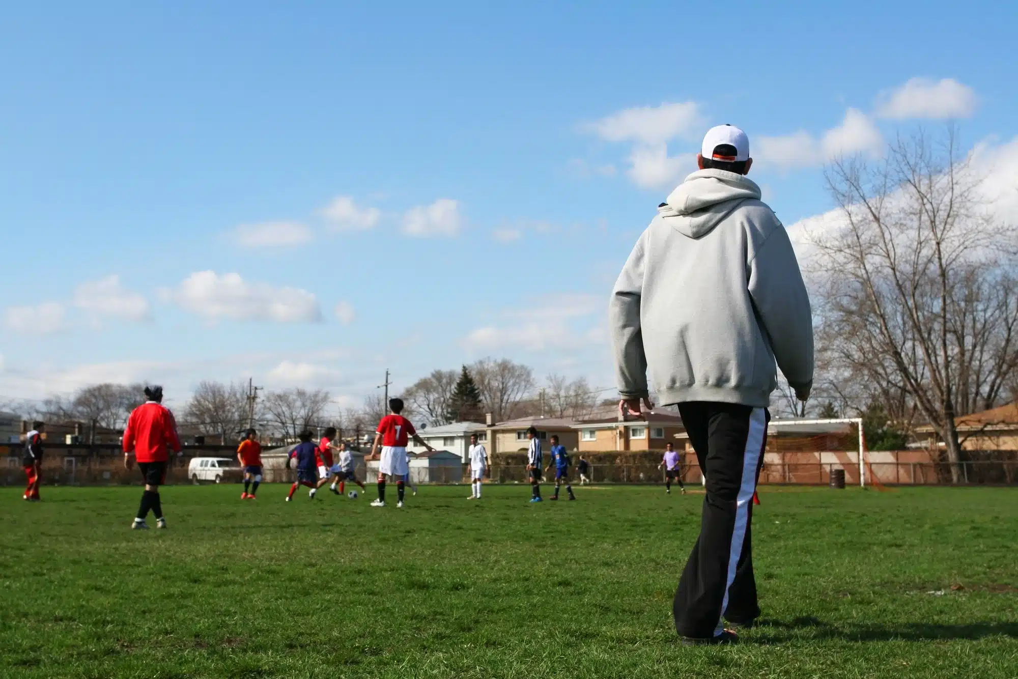 Coach stares at players on field