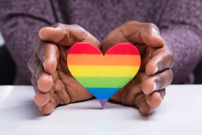 man protecting lgbtq heart