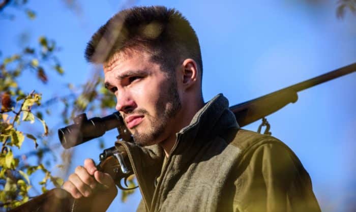 gun owner walking with rifle