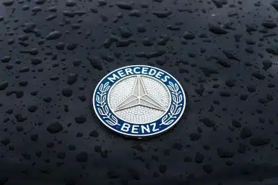 Mercedes-Benz logo on wet car hood - mercedes bluetec