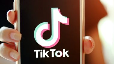 A person holds up a smartphone with TikTok on the screen - tiktok ban