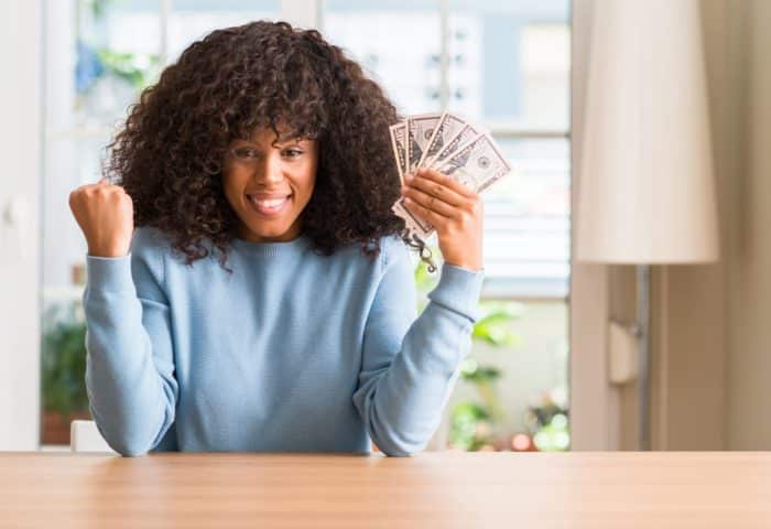 woman holding money from drywall settlement