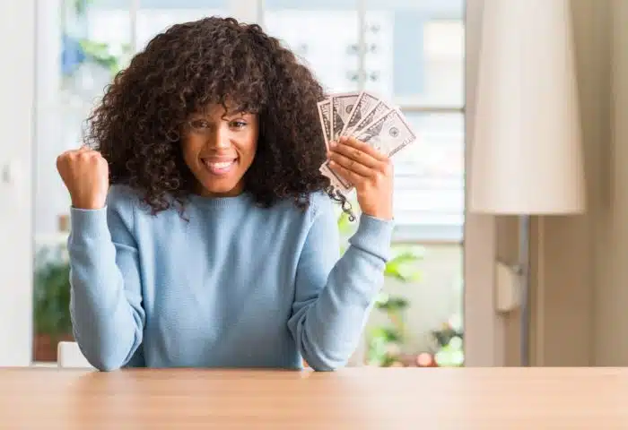 woman holding money from drywall settlement
