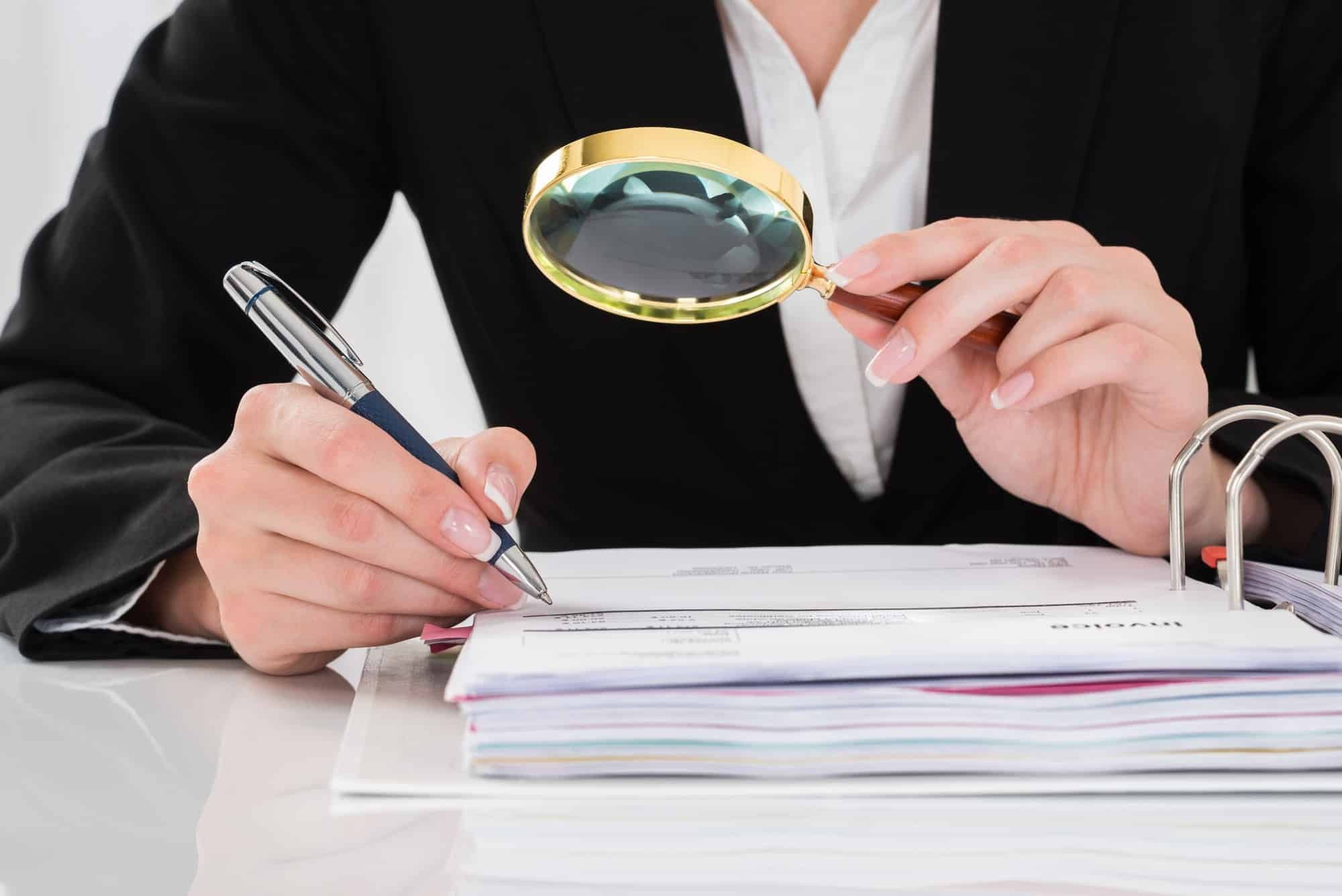 female employee inspecting accounting numbers