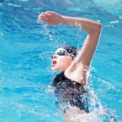 A onetime competitive athlete is suing former USA Swimming coach Scott MacFarland over allegations he raped her when she was 17.