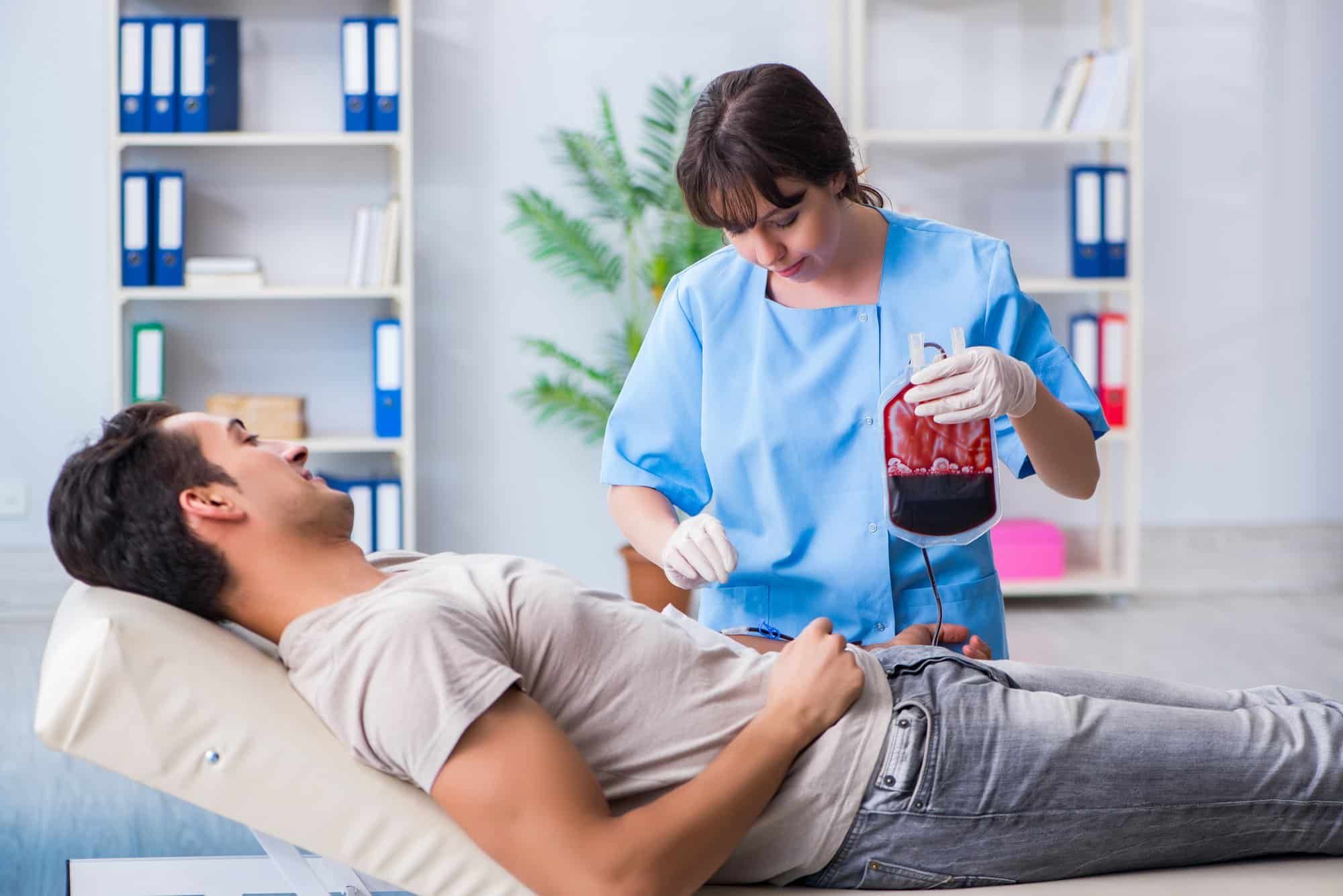 Male patient receives blood transfusion in hospital