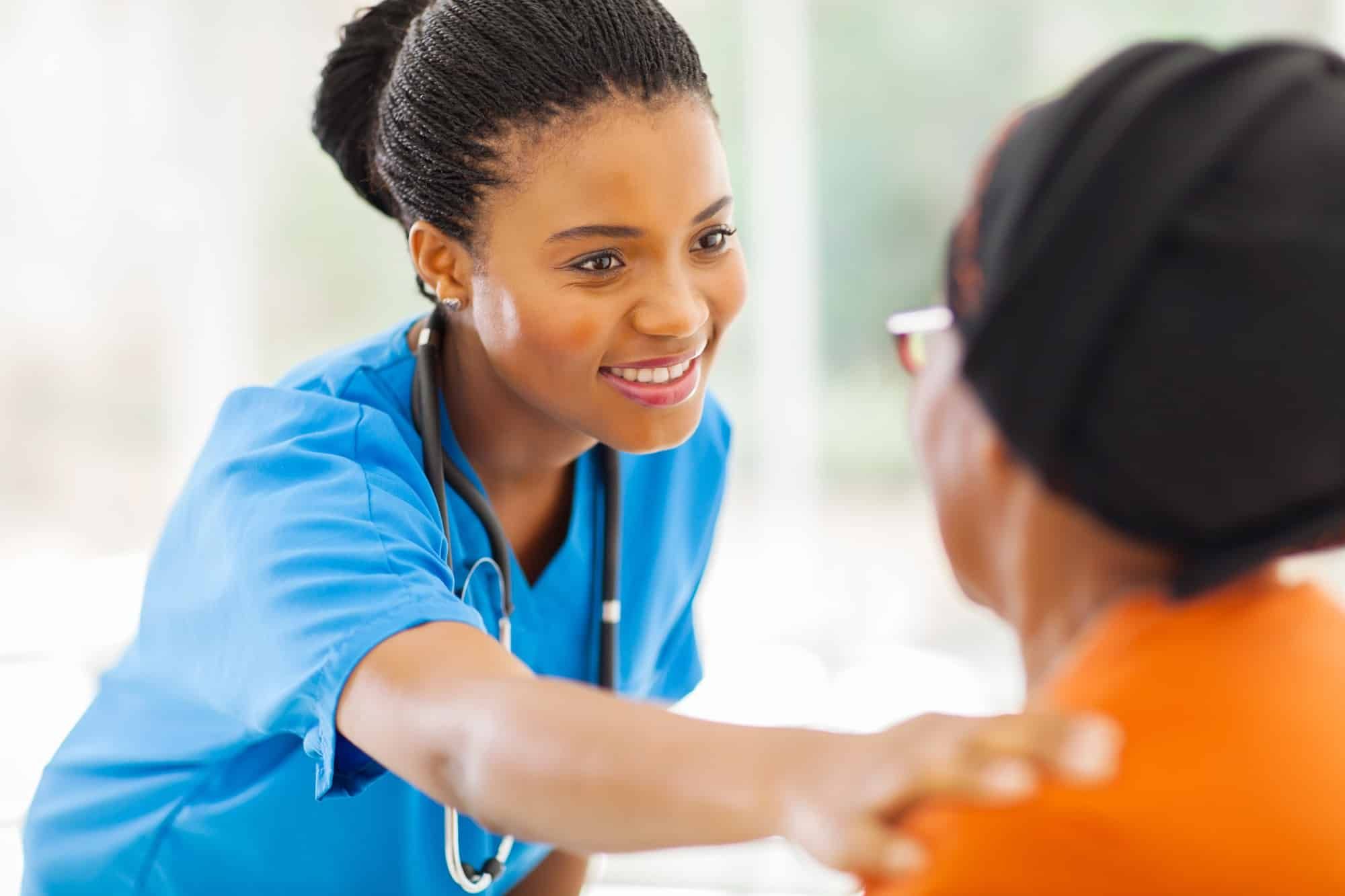 Nurse tends to elderly patient