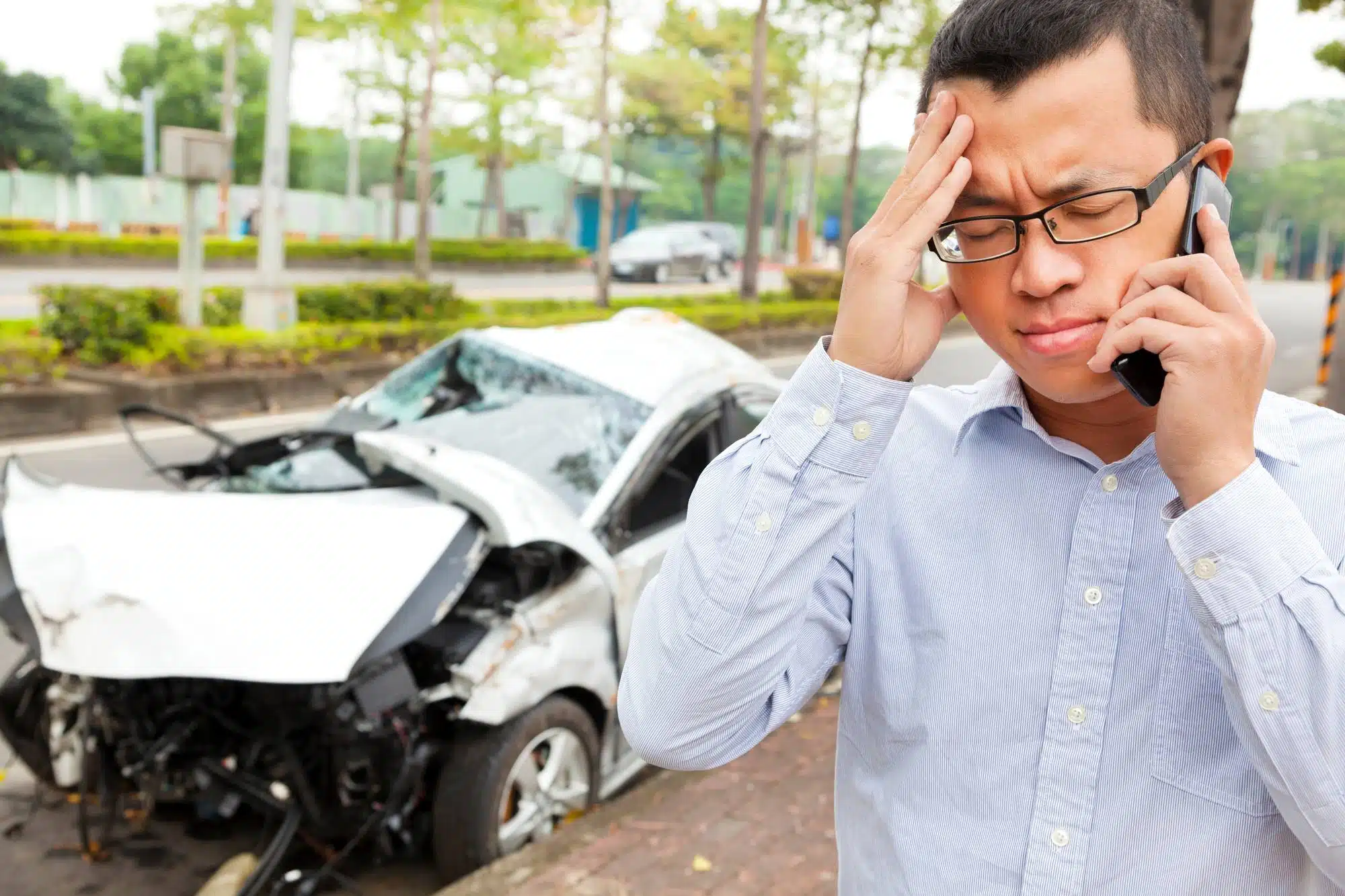 Upset male driver on phone after car crash