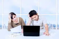 asian man and woman trying to understand insurance papers