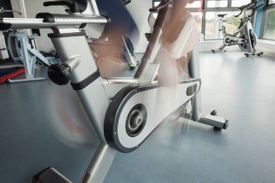 Closeup of a person's feet pedaling fast on a stationary bike - peloton pedals