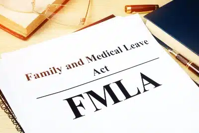 Paperwork lying near books reads "Family and Medical Leave Act FMLA" - instacart