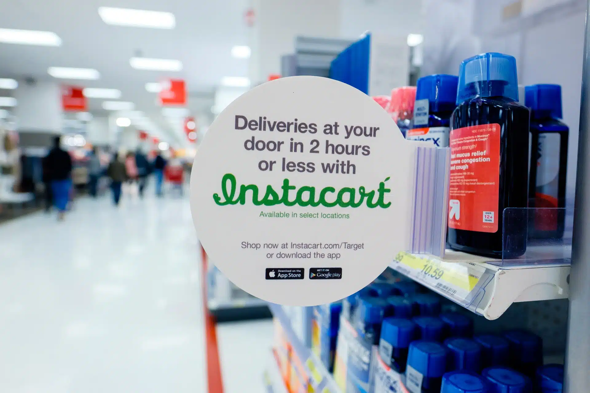 An InstaCart flag is attached to a shelf at a pharmacy