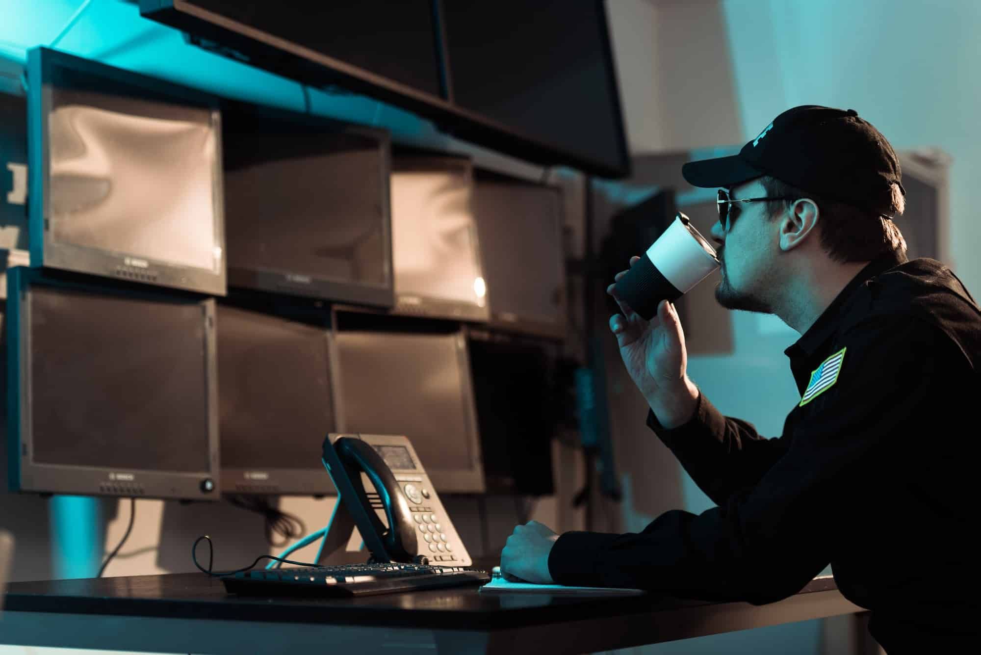 prison guard monitoring screens