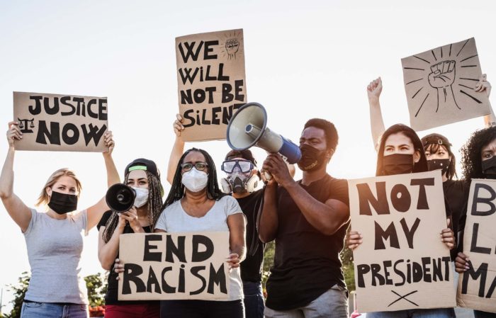 iowa racial justice protesters holding signs