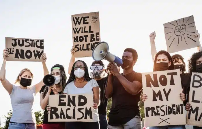 iowa racial justice protesters holding signs