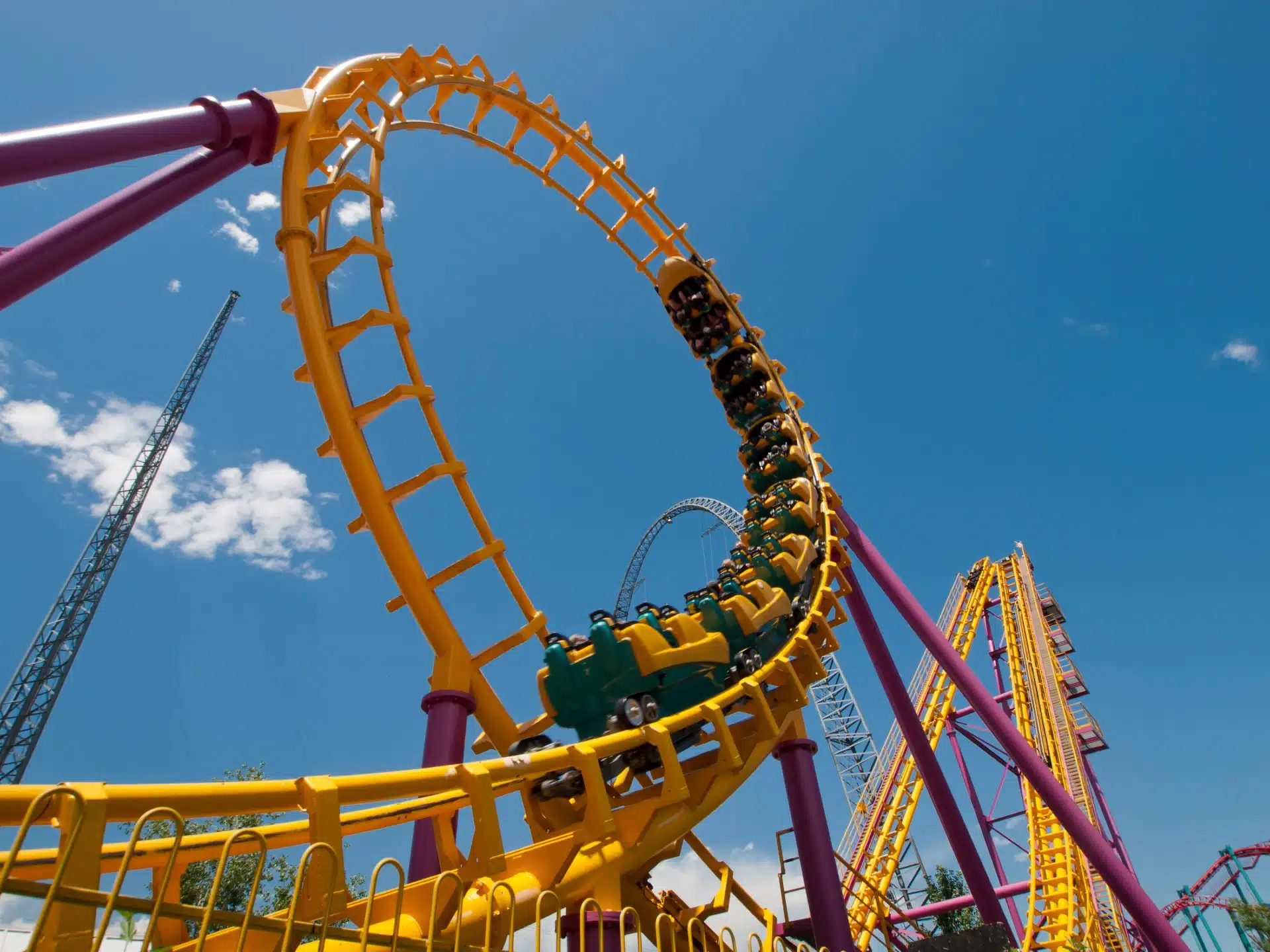 People ride a roller coaster at an amusement park - Six Flags