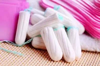 Tampons in a pile alongside other feminine hygiene products - tampon safety