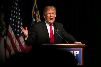 Donald Trump stands behind a podium and gestures - election day