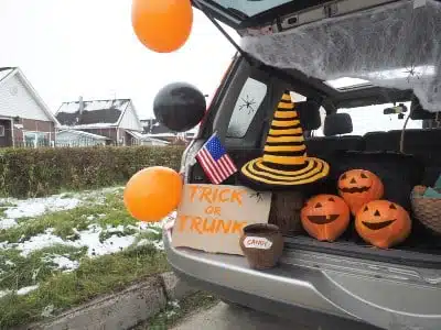 A vehicle is set up for trunk-or-treating, with snow on the ground - safety tips on halloween