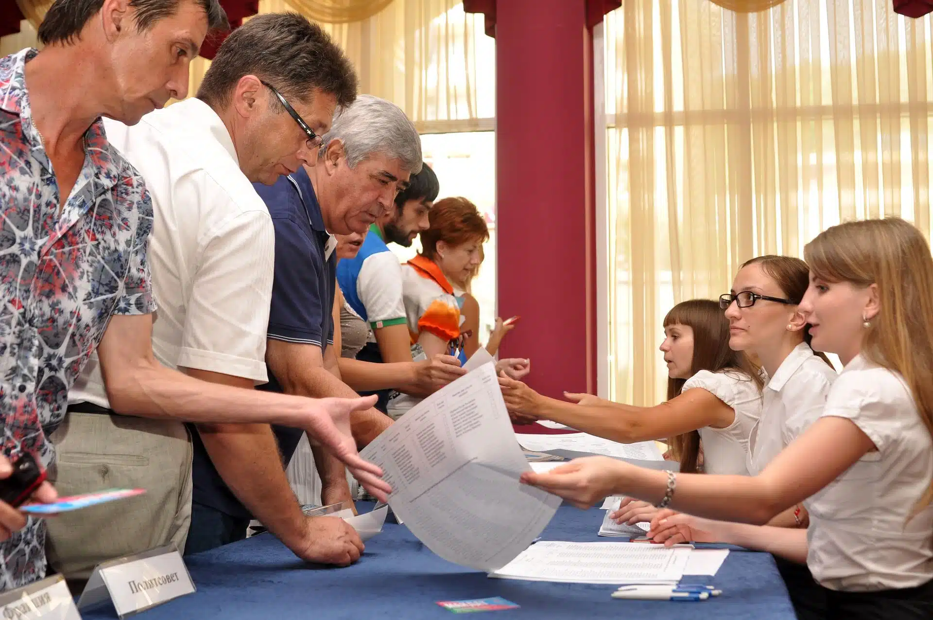 Voters pick up ballots from poll workers at a polling place - Colorado voters