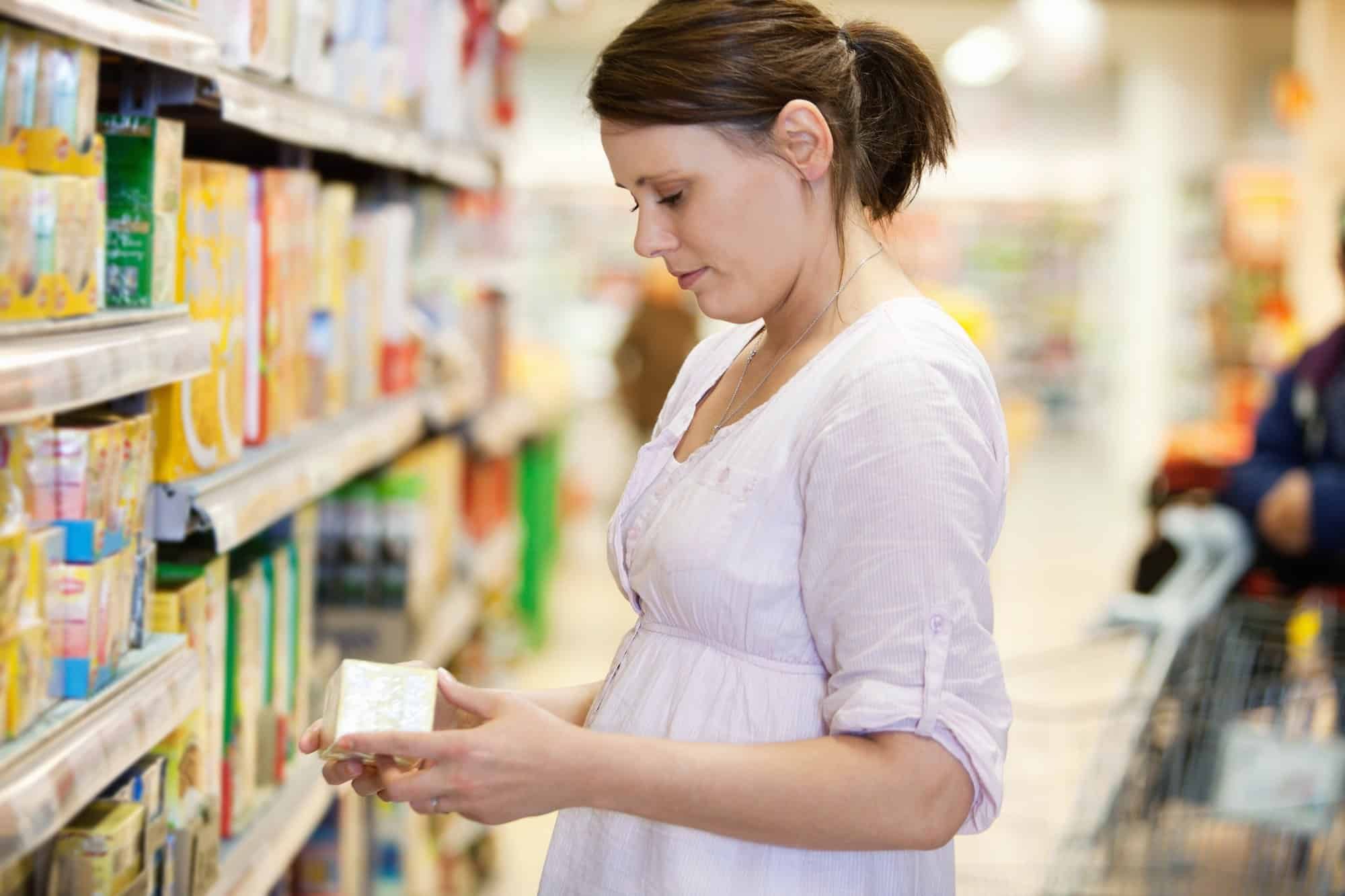 Woman looking at box regarding the Annie's Bunny Fruit Snacks class action lawsuit filed 
