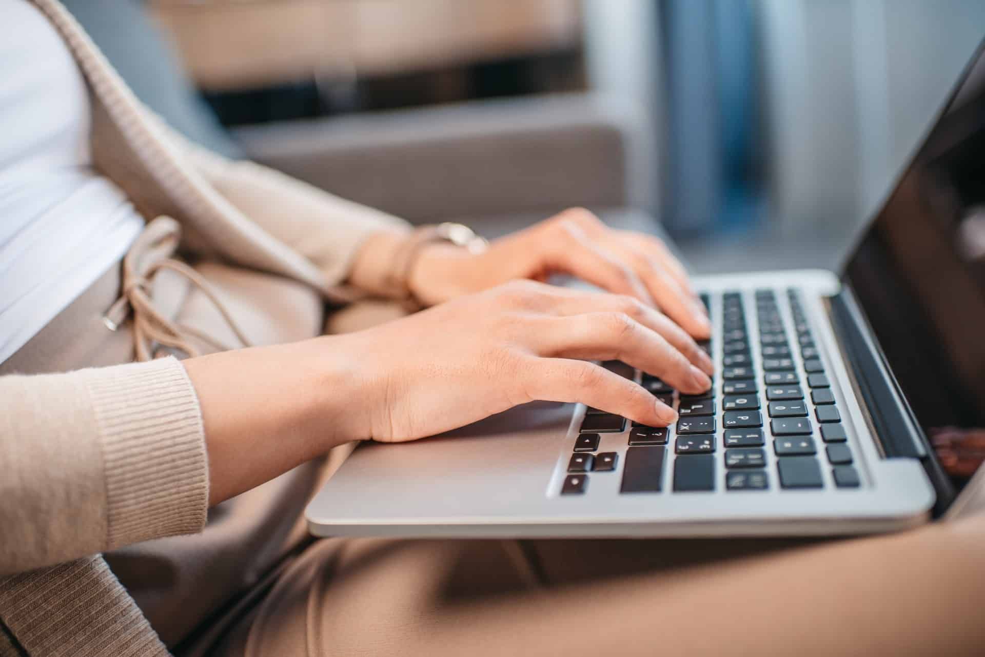 Closeup of a woman using a laptop on her lap - privacy law
