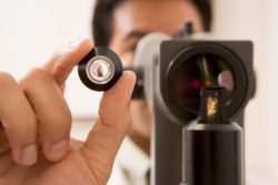 Doctor looks through eye exam machine