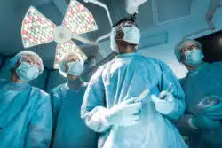 Doctors with gloves and tools in operating room