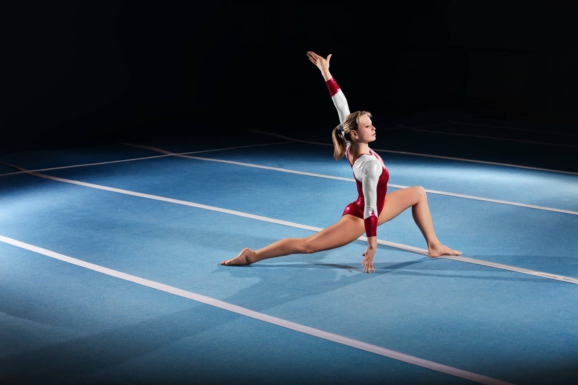 Female gymnast competes in stadium