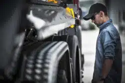 Male truck driver checks load