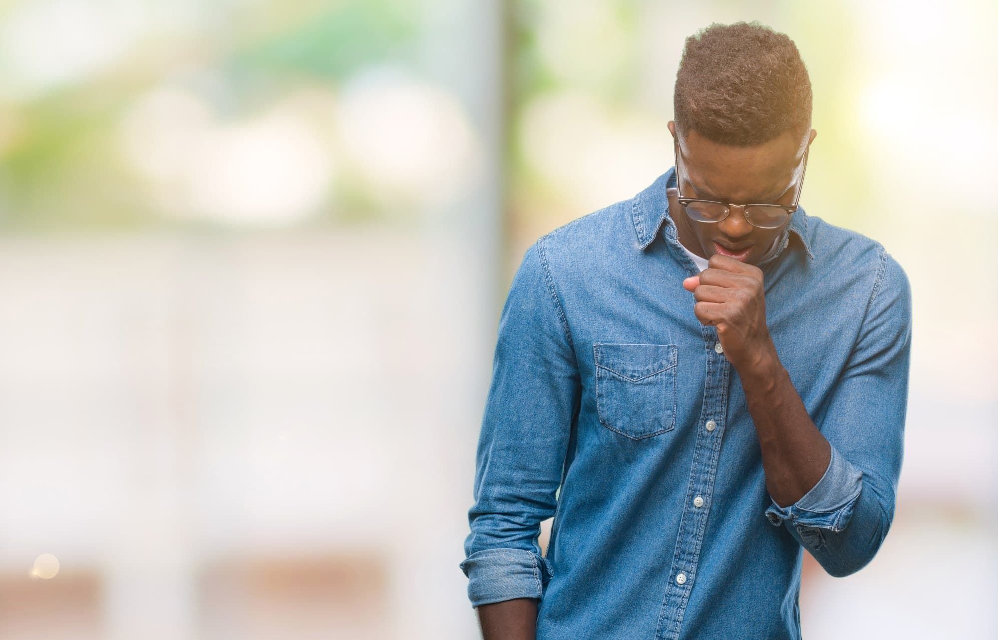 Man coughs while walking