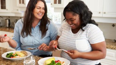 Two overweight women eating a light dinner