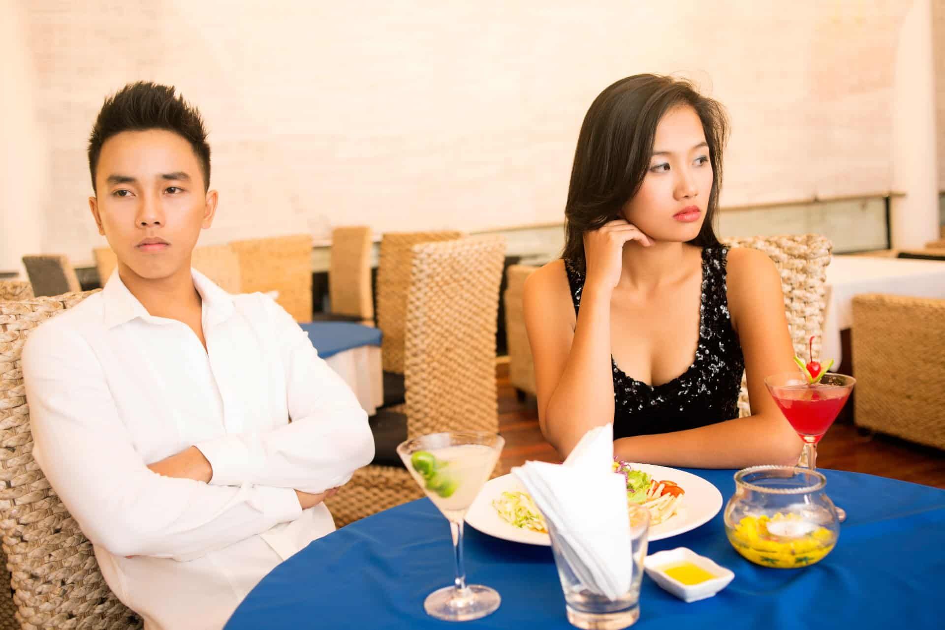 A couple on a bad date look away from each other - It's Just Lunch