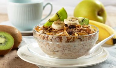 Cereal with fruit in a bowl near a coffee cup and saucer - post foods